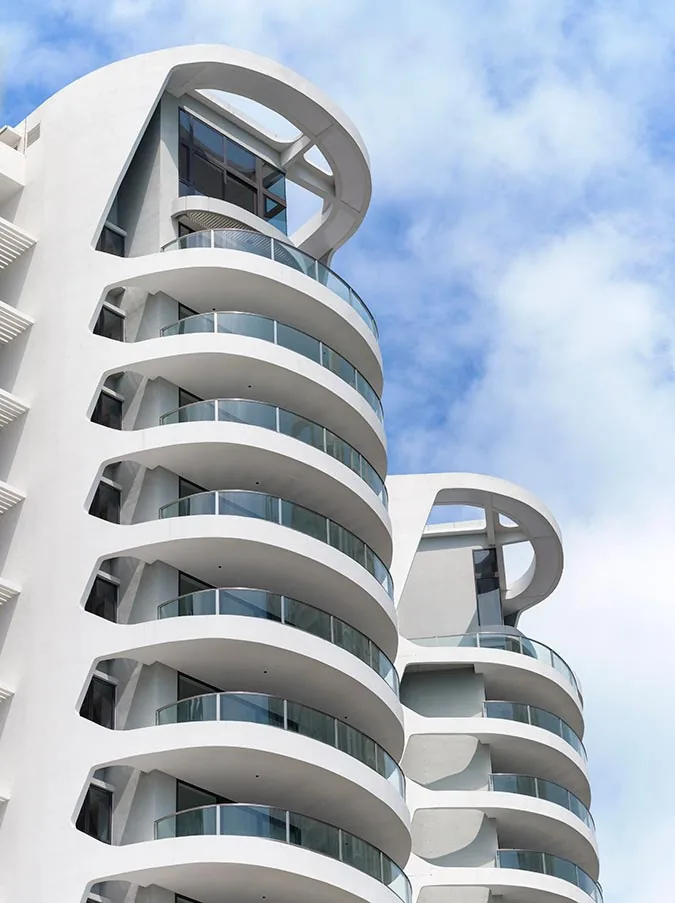 Cape Royale, photograph: the rounded crown and stacked curved balconies of a tower, with a second tower behind