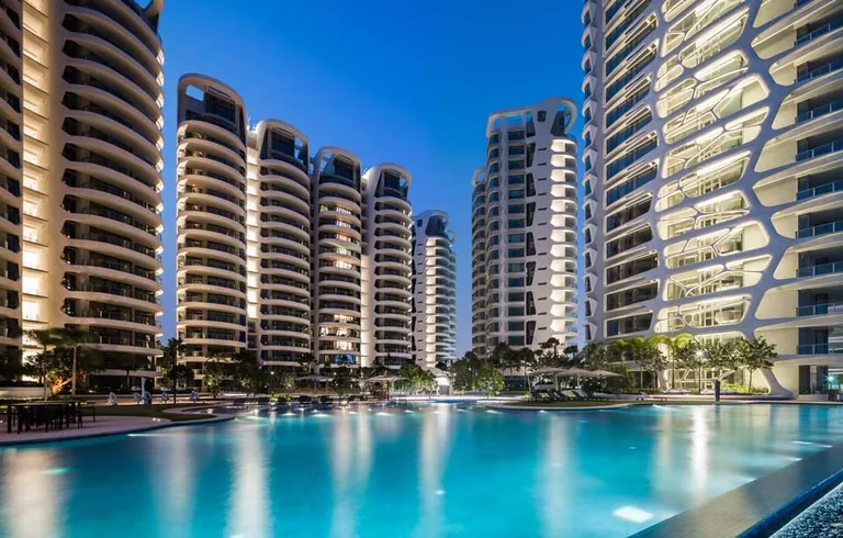 Cape Royale, photograph: the lit towers reflected in the swimming pool at dusk under a deep blue sky