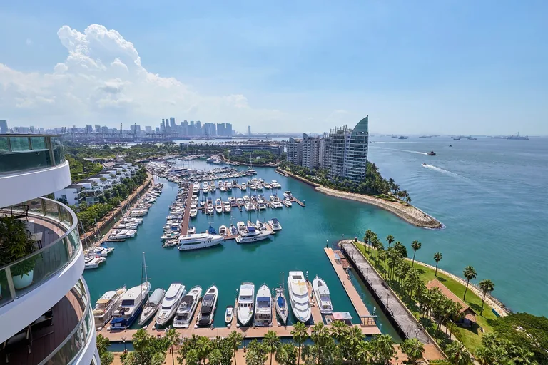 Cape Royale, photograph: the yachts and pontoons of ONE&deg;15 Marina seen from a tower, with the breakwater, the sea and the city skyline beyond